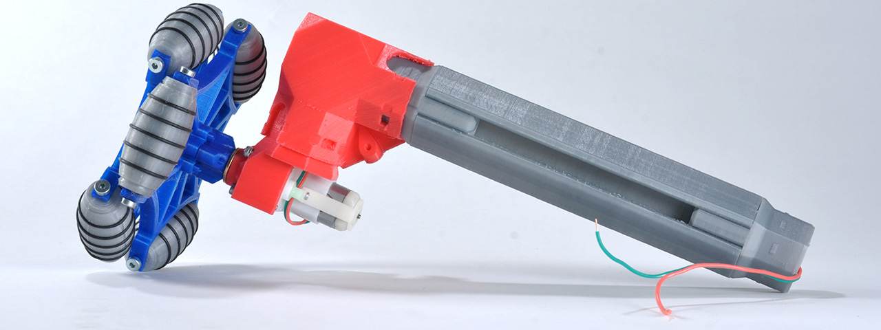 A MakeWiths extrusion joined to a red printed motor mount with blue omni wheels